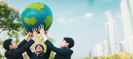 Earth day concept with big Earth globe held by group of asian business people team promoting environmental awareness with environmentally sustainability and ESG principle for brighter future. Gyreの写真素材