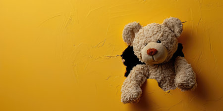 Close up view picture of the hollow yellow hole on the the wall that show the teddy stay inside the wall that has been made from some material yet still can break to look through other side. AIGX03.の素材