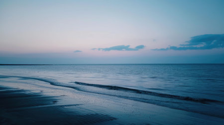 A picturesque beach with waves crashing against the shore under the colorful sunset sky, creating a mesmerizing natural landscape AIG50の素材