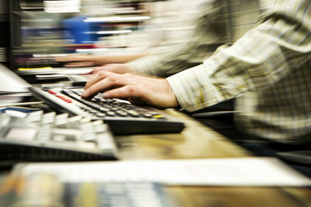 Skilled journalist typing typewriter while working and writing the journal. Professional writer writing, designing manuscript and preparing for sending to editor with blurring background. AIG42.の素材