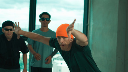 Group of multicultural hipster practice break dance with cityscape or sky scrapper view. Attractive...
