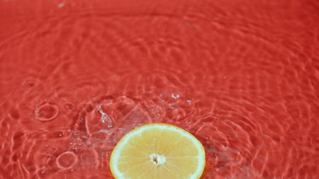Close up of fresh orange slices water splashing on separated background. Macrography of sliced orange falling and dropping with splashing and spilling water. Freshness and hydration concept. Pabulum.の写真素材