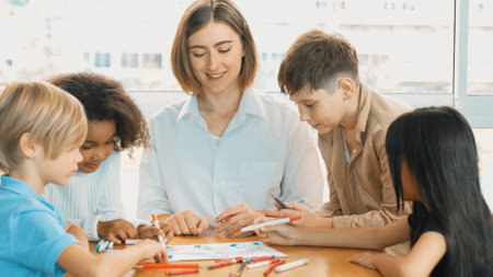 Professional caucasian teacher telling story to diverse student while sitting at table with storybook and colored book. Smart learner listening story while colored picture from instructor. Erudition.の写真素材
