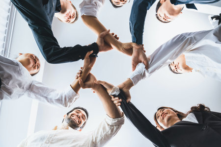 Business team joining hand in circular together symbolize successful group of business partnership and strong collective unity teamwork in diverse culture community workplace. Prudentの写真素材
