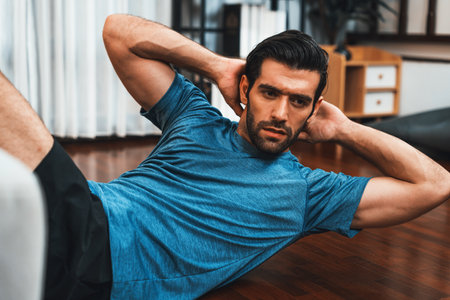 Athletic body and active sporty man using furniture for effective targeting muscle gain exercise at...