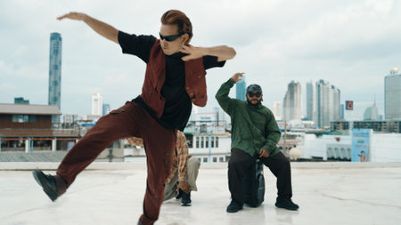 Group of professional hip hop dancer practice break dance on roof top. Skilled choreographer show...