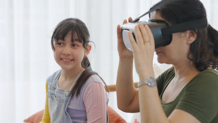 Granddaughter control laptop guide grandmother to dive in metaverse with VR. Senior adapt to technology activity communicate new generation kid cross generation gap strengthen family. Divergence.の写真素材