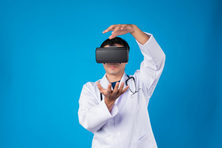Smart doctor wearing VR headset connect metaverse touching screen with medicine research treatment futuristic tech hologram virtual reality intelligent world isolate blue background. Contrivance.の写真素材