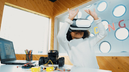 Creative girl wearing VR headset to learning in metaverse. Funny kid enjoy to wearing AI headset and enter to virtual world program in STEM technology class. Innovation. Future lifestyle. Erudition.の写真素材