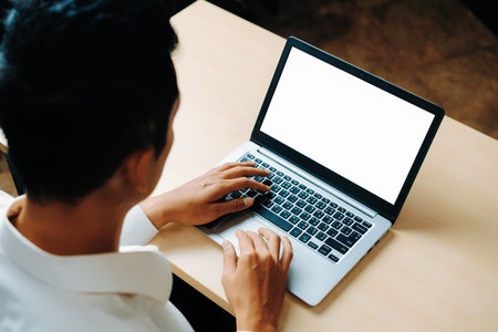 Business person or office worker using laptop computer while sitting at desk. udsの写真素材