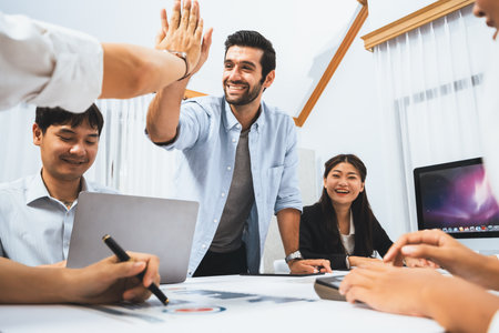 Analyst team leader celebrate and high five together with his colleague after successful data...