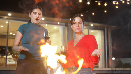 Family gather celebrate holiday. Mother and grandmother drink wine, grill food for dinner party with...
