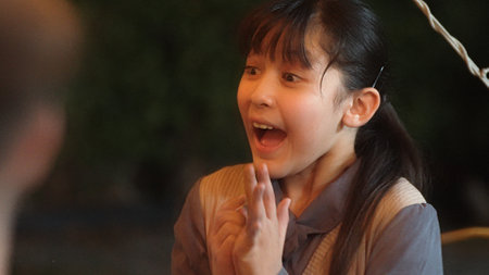 Girl together with family celebrate holiday in garden surprised from getting gift. Outdoor camping activity to relax with nature and spend time with lovely parents strengthen family bond. Divergence.の写真素材