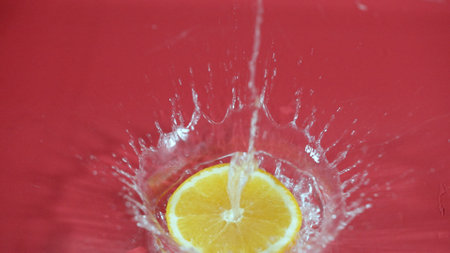 Close up of fresh orange slices water splashing on separated background. Macrography of sliced orange falling and dropping with splashing and spilling water. Freshness and hydration concept. Pabulum.の写真素材