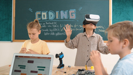 Energetic child wearing Vr headset while enter virtual world at classroom. Student programing system while code engineering prompt software while boy fixing electronic board. Pedagogy.の写真素材