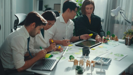 Professional smart business team discussing about using clean energy and sustainable investment at meeting table with wind mill, document with environmental graph and wooden house model. Alimentation.の写真素材