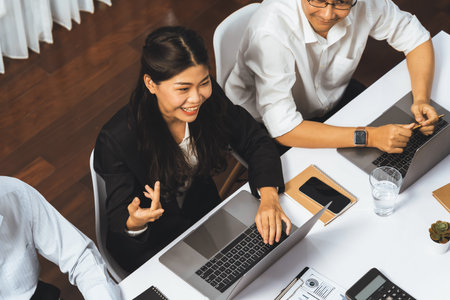 Analyst team utilizing BI Fintech to analyze financial data at table in meeting room. Businesspeople analyzing BI dashboard power on paper for business insight and strategic marketing planning.Prudentの写真素材