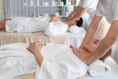 Caucasian couple customer enjoying relaxing anti-stress spa massage and pampering with beauty skin recreation leisure in day light ambient salon spa at luxury resort or hotel. Quiescentの写真素材