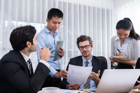Diverse of business people from various ethnic group working in modern office environment. Productive and multi ethnic office workers engage in discussion for strategic business marketing. Meticulousの写真素材