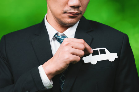 Businessman holding EV car icon symbolize eco-friendly business corporation committed to environmentally friendly transportation and zero CO2 emission. Corporate responsible and EV technology. Gyreの写真素材