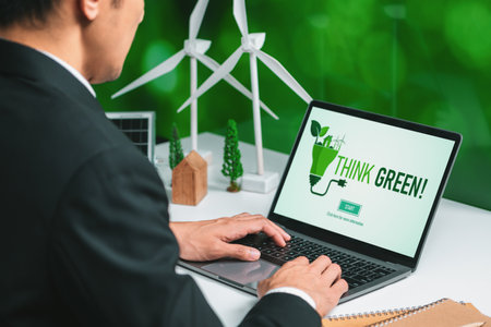 Businessman working in office developing plan or project on eco-friendly alternative energy with solar cell technology display on computer screen for greener environment as apart of CSR effort. Gyreの写真素材