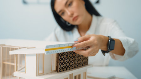 Closeup portrait image of professional young beautiful engineer architect using triangular scale...
