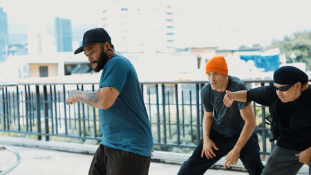 Hipster perform break dancing while partner dancing together at corridor, modern mall. Hip-hop music...