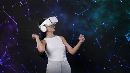Excited smiling Asian woman looking through VR metaverse neon digital universe starry zodiac with...