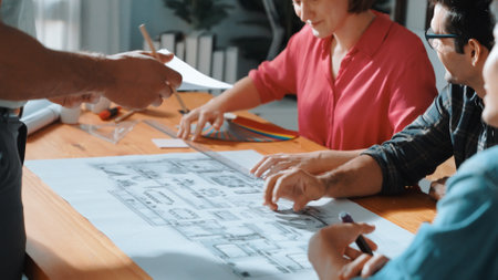 Top view of interior designer planing building while project manager working and holding coffee....