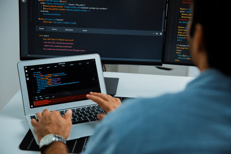 Concentrating in smart IT developer working software development coding on laptop and pc, creating virus firmware application program for latest update version on website at modern office. Surmise.の写真素材