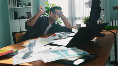 Skilled interior designer work on palettes and crumpled paper. Top view of skilled business man run out of idea while sleeping at meeting table. Project manager crumpled and throw paper. Symposium.の写真素材