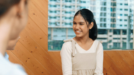 Young student smiling while listening other student in meeting or group discussion. Cute teenager...