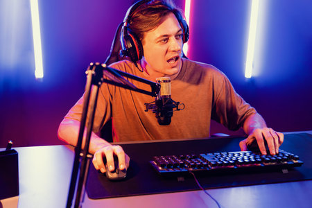 Host channel of gaming smart streamer playing online game to be winner, wearing headphone with...