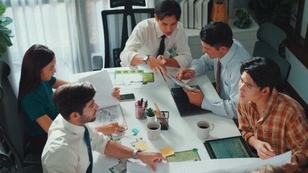 Group of diverse team planning strategy while sitting at table with project plan. Top aerial view of smart business people working together to brainstorm and design house construction. Alimentation.の写真素材