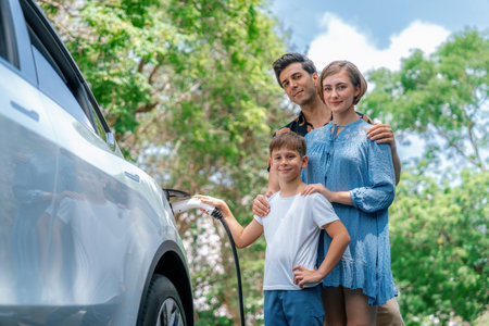 Family road trip vacation with electric vehicle, lovely family recharge EV car with green and clean energy. Natural and eco friendly car travel for sustainable environment. Perpetualの写真素材