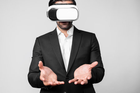 Smart business man with suit holding something while VR goggle to connect metaverse. Professional...