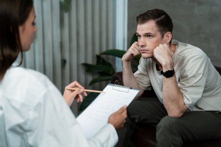 Stressed and depressed patient seeking help from psychiatrist with mental illness and depression in office during mental therapy session. Mental health treatment and medical care concept. Unveilingの写真素材