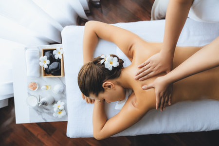Panorama top view woman customer enjoying relaxing anti-stress spa massage and pampering with beauty skin recreation leisure in day light ambient salon spa at luxury resort or hotel. Quiescentの写真素材