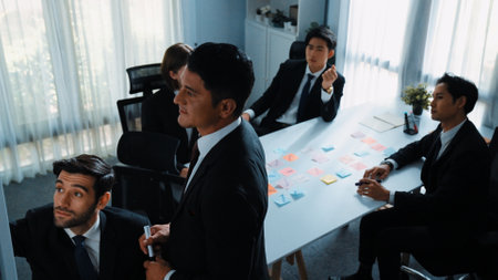 Top view of businessman explain marketing strategy and choose idea by using colorful stick notes. Professional marketing team brainstorming and planning financial plan at meeting room. Directorate.の写真素材