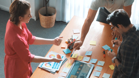 Top view of manager writing idea on sticky notes and explain idea about web design. Professional...