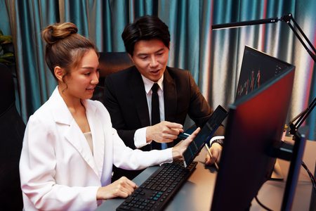 Businesswoman holding tablet on dynamic stock exchange statistic online showing to partners to...