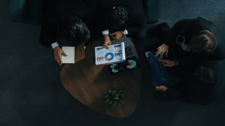 Top down aerial view of professional business man handed out business document to investor while manager placed tablet display financial statistic graph on table and listen presentation. Directorate.の写真素材