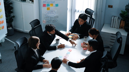 Top view of business people brainstorm idea by using sticky notes while planning marketing strategy at meeting room. Group of diverse team discuss about financial plan. Teamwork concept. Directorate.の写真素材