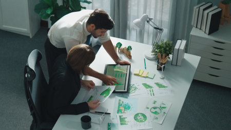 Professional business man presenting sustainable idea to manager by using tablet display ESG environmental social governance. Smart manager working together planning to use clean energy. Alimentation.の写真素材