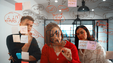 Creative business team brainstorming and sharing marketing idea about start up project by writing...