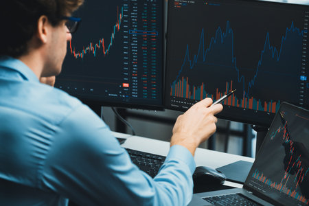 Working young professional business trader concentrating on market stock graph investing in real...