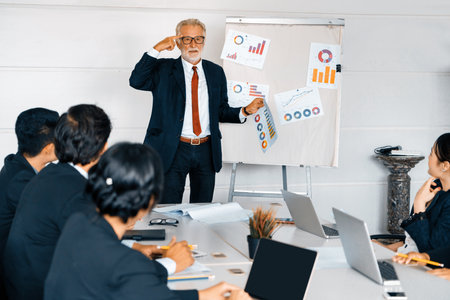 Senior leader speaker speaks to public people audience in training workshop or conference. Mature lecturer is CEO executive manager leading symposium event. International business seminar concept. udsの写真素材