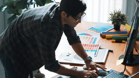 Professional designer looking and designing logo graphic at meeting. Closeup of business man working...