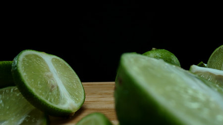 Close-up, a vibrant slice of fresh lime rests upon a rustic wooden cutting board, exuding freshness...