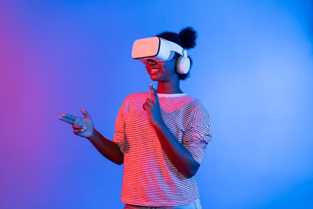 Hunting African gamer wearing VR turning metaverse world playing gun shooting hunter isolate blue neon light connect victory animal hunting futuristic technology hologram virtual reality. Contrivance.の写真素材